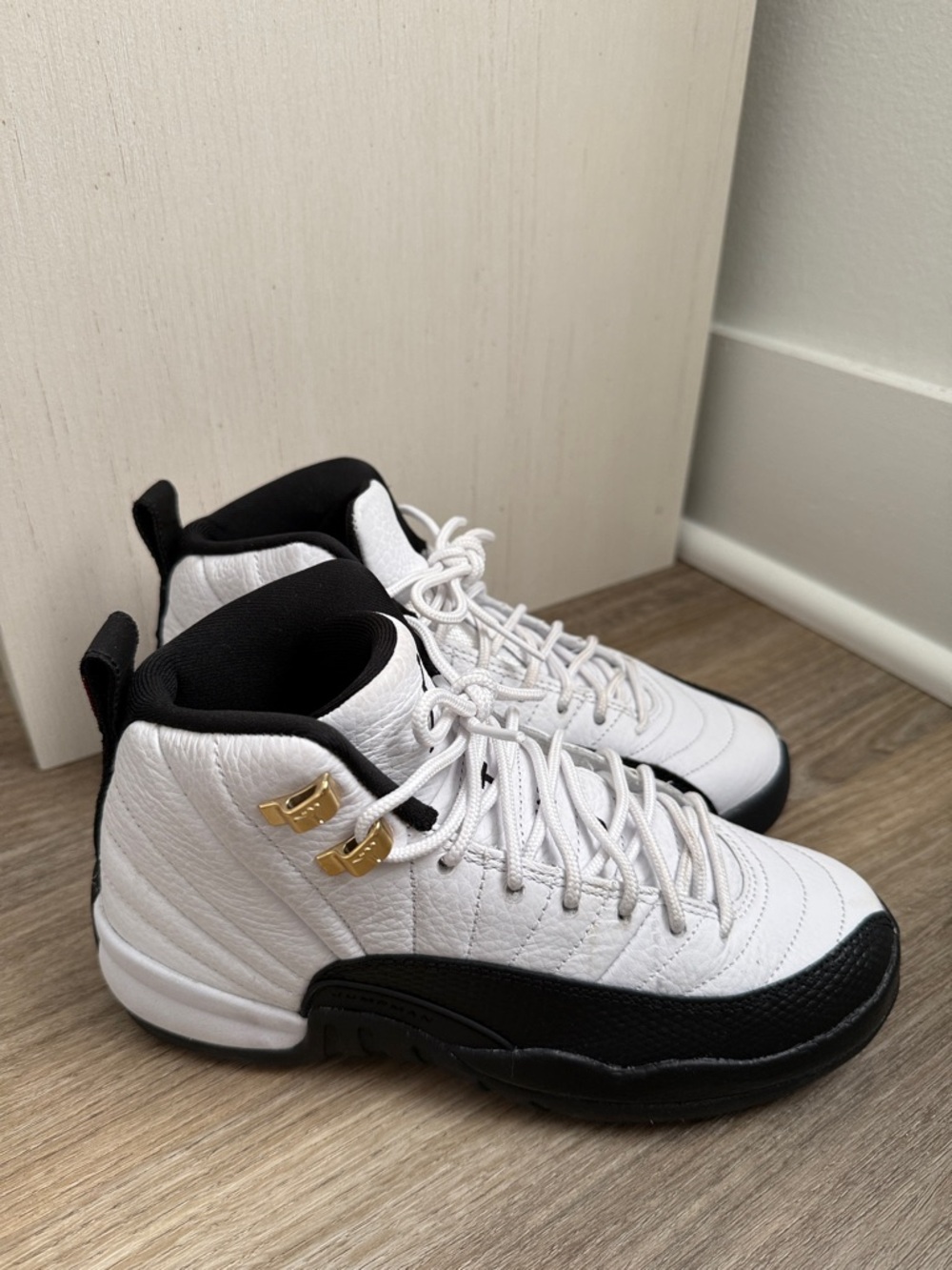 Kids White and Black Jordan 12s.